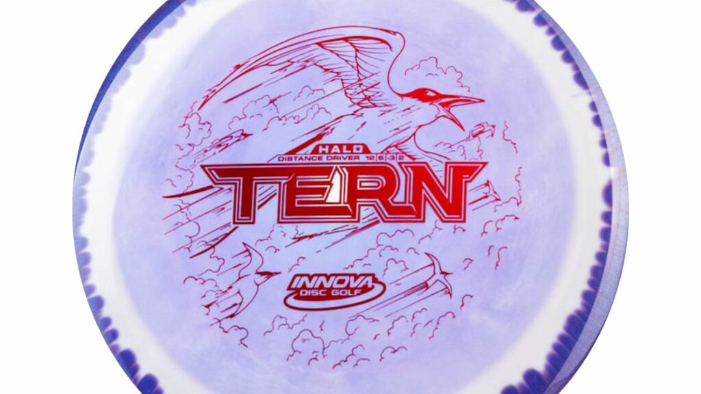 An Innova Tern Disc with Purple Color with white marble effect and Magenta Stamp. 

Description for top to bottom
Text: Halo, Distance Driver, Flight numbers: 10, 8, -3, 2


Image: depicts a Tern bird gracefully soaring amidst a backdrop of fluffy clouds

Text: Innova Disc Golf